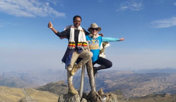 Two people in Ethiopia on mountain, at the top